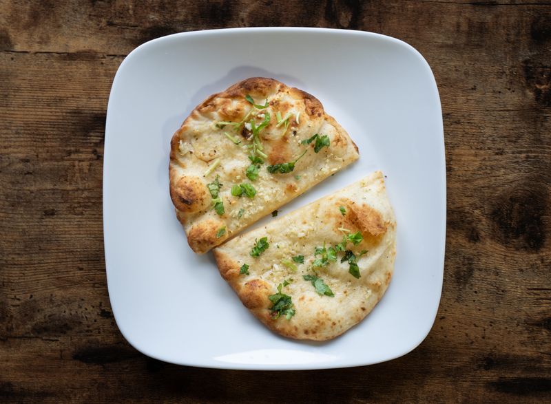 Wood-fired garlic bread with herbs and mozzarella